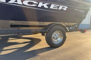 2026 Tracker Pro Guide V-16 WT boat on trailer, side view in sunlight.