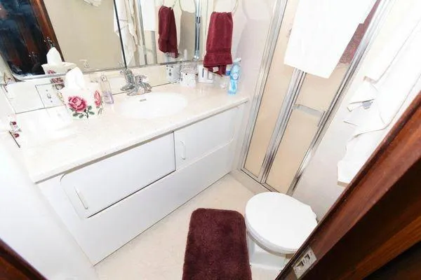  Yacht Photos Pics Bathroom interior of 1988 Hatteras 54 Motor Yacht with modern fixtures and decor.
