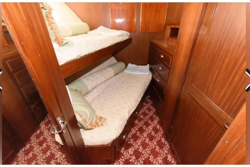 Yacht Photos Pics 1988 Hatteras 54 Motor Yacht cabin with wooden interior and bunk beds.