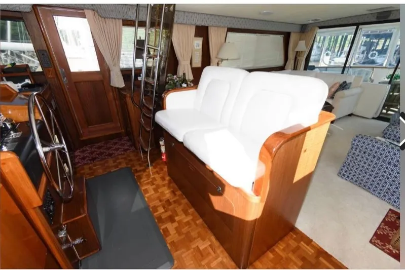  Yacht Photos Pics Interior of 1988 Hatteras 54 Motor Yacht with white seating and wooden accents.