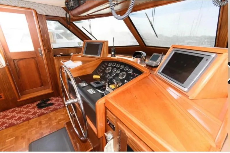  Yacht Photos Pics 1988 Hatteras 54 Motor Yacht helm with wooden dashboard and modern navigation equipment.