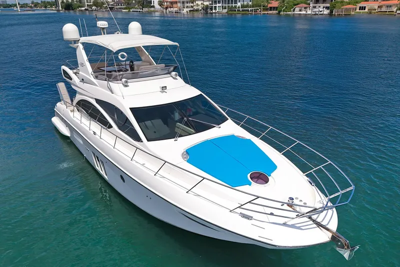 Ll On The Rocks Yacht Photos Pics Luxury 2012 Azimut Fly 53 yacht cruising on clear blue water.