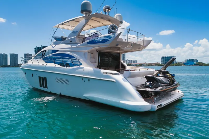 Ll On The Rocks Yacht Photos Pics Luxury Azimut Fly 53 yacht from 2012 on clear blue water, city skyline in background.