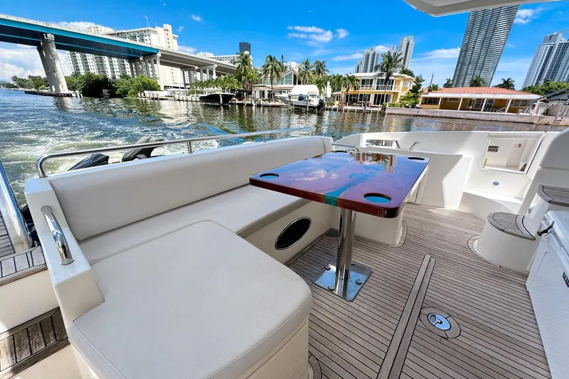 Ll On The Rocks Yacht Photos Pics Luxurious 2012 Azimut Fly 53 yacht deck with seating, table, and scenic waterfront view.