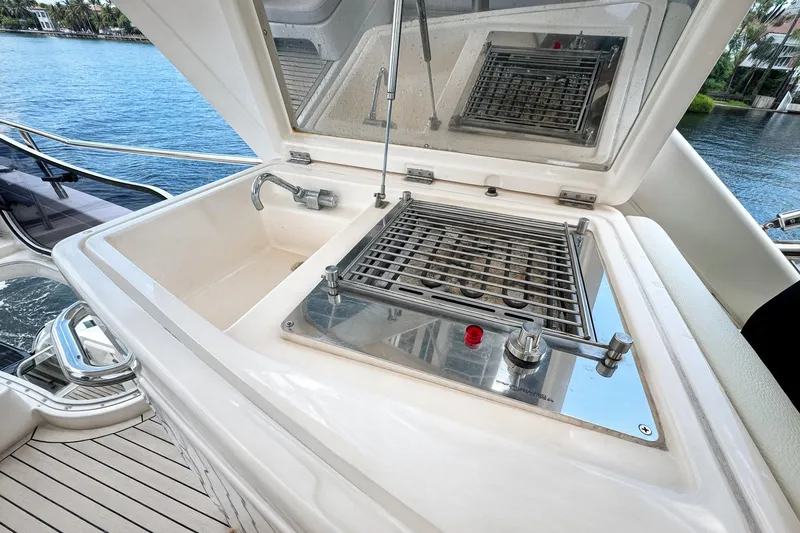 Ll On The Rocks Yacht Photos Pics Outdoor grill and sink on 2012 Azimut Fly 53 yacht, overlooking serene water.