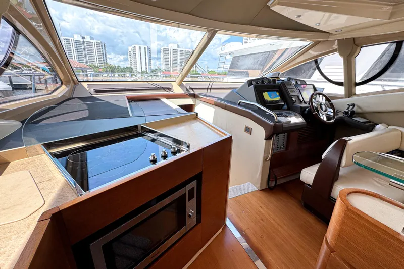 Ll On The Rocks Yacht Photos Pics Luxurious interior of 2012 Azimut Fly 53 yacht with modern helm and kitchen area.