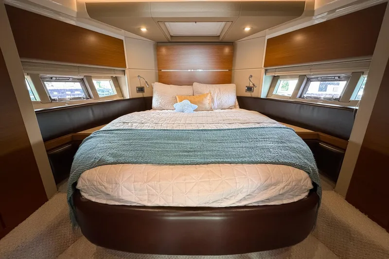Ll On The Rocks Yacht Photos Pics Luxurious bedroom interior of 2012 Azimut Fly 53 yacht with elegant bedding and natural light.