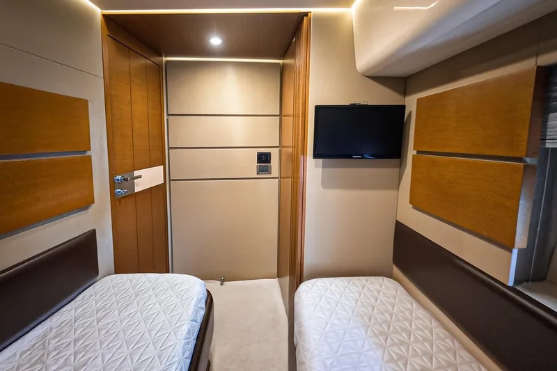 Ll On The Rocks Yacht Photos Pics Luxurious cabin interior of 2012 Azimut Fly 53 yacht with twin beds and wall-mounted TV.