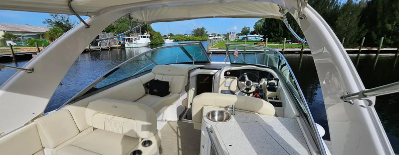  Yacht Photos Pics 2018 Regal 33 XO boat interior with seating and helm, docked on a sunny day.