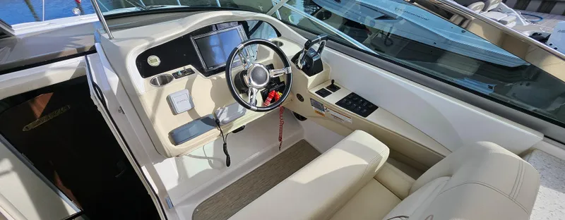  Yacht Photos Pics 2018 Regal 33 XO boat cockpit with steering wheel and navigation controls.