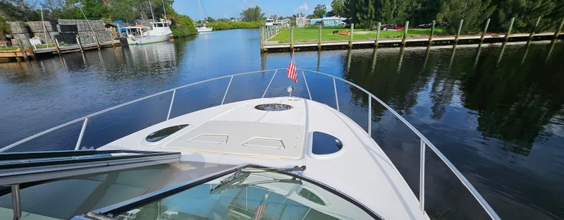  Yacht Photos Pics 2018 Regal 33 XO boat cruising on a calm river with scenic surroundings.