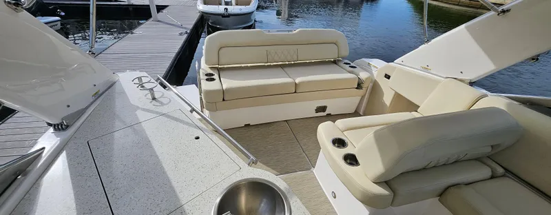  Yacht Photos Pics 2018 Regal 33 XO boat interior with beige seating, docked by the water.