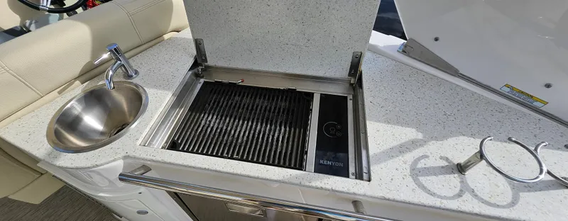  Yacht Photos Pics Outdoor kitchen on 2018 Regal 33 XO boat with grill and sink.