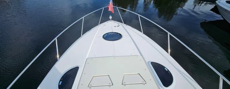  Yacht Photos Pics 2018 Regal 33 XO boat bow with American flag on calm water.