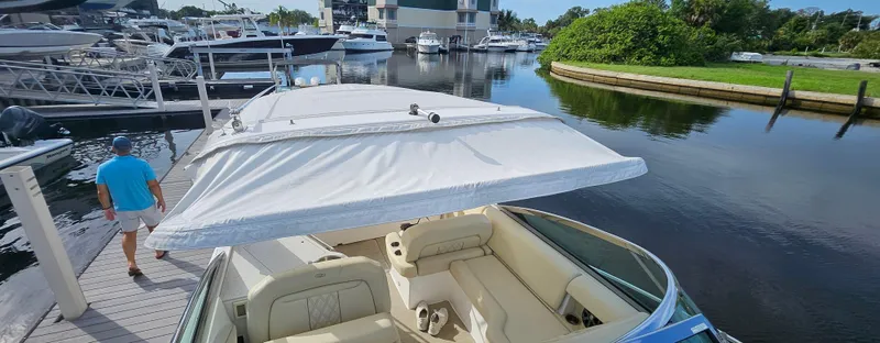  Yacht Photos Pics 2018 Regal 33 XO boat docked at marina, featuring spacious seating and canopy.