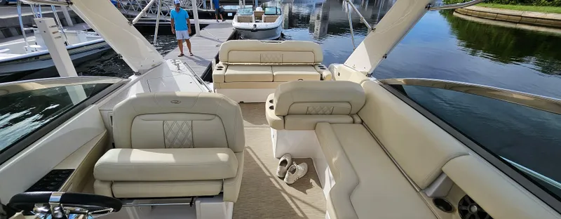 Yacht Photos Pics 2018 Regal 33 XO boat interior with beige seating at a marina.