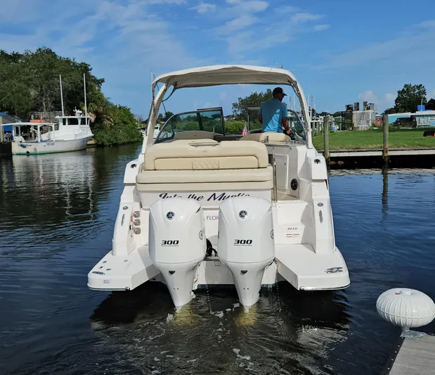  Yacht Photos Pics 2018 Regal 33 XO boat with dual engines on a calm waterway.