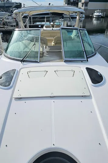  Yacht Photos Pics 2018 Regal 33 XO boat with open deck and glass windshield at marina.
