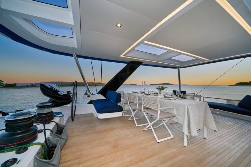 Amada Mia Yacht Photos Pics Luxurious Lagoon Sixty5 yacht deck with elegant dining setup at sunset, 2021 model.