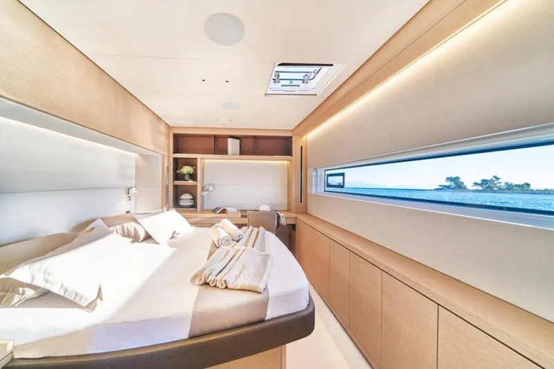 Amada Mia Yacht Photos Pics Luxurious interior of 2021 Lagoon Sixty5 yacht cabin with ocean view.