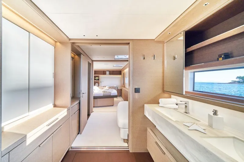 Amada Mia Yacht Photos Pics Luxurious interior of 2021 Lagoon Sixty5 yacht with modern bathroom and ocean view.