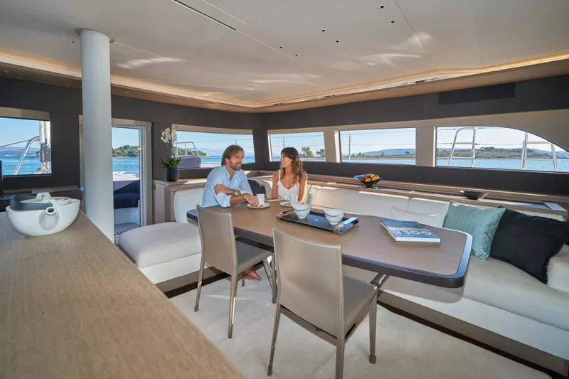 Amada Mia Yacht Photos Pics Couple dining in luxurious Lagoon Sixty5 yacht interior, 2021 model.