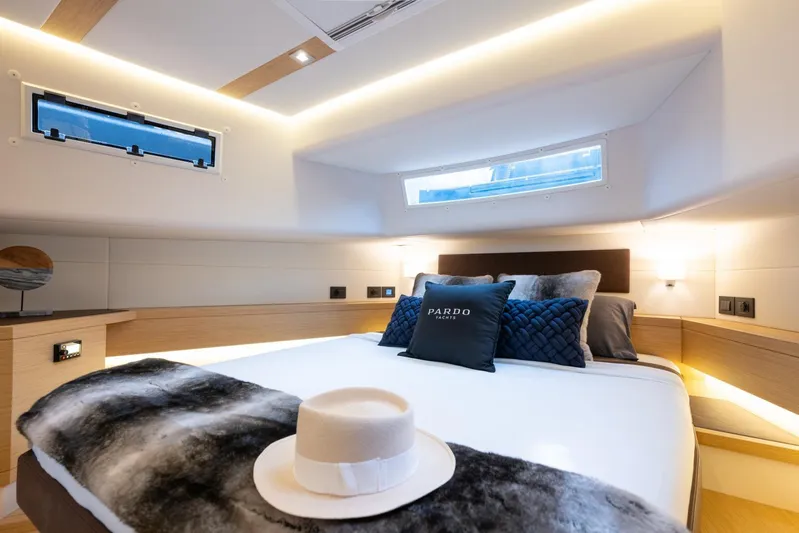  Yacht Photos Pics Luxurious cabin interior of 2022 Pardo Yachts 50, featuring elegant bedding and modern design.