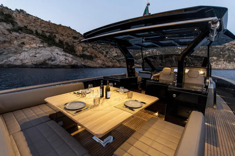  Yacht Photos Pics Luxurious 2022 Pardo Yachts 50 with elegant dining setup, scenic coastal backdrop.
