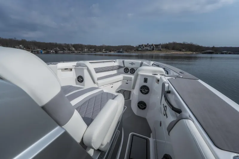  Yacht Photos Pics 2026 Fountain 38 SCX boat interior with luxurious seating on a calm lake.