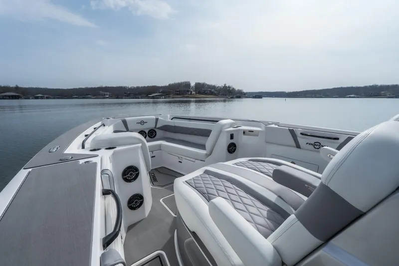  Yacht Photos Pics 2026 Fountain 38 SCX boat interior with luxurious seating on a calm lake.