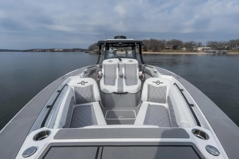  Yacht Photos Pics 2026 Fountain 38 SCX boat with luxurious seating on a calm lake.