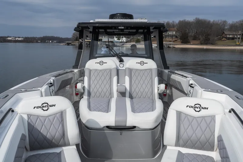  Yacht Photos Pics 2026 Fountain 38 SCX boat interior with luxurious seating on a calm lake.