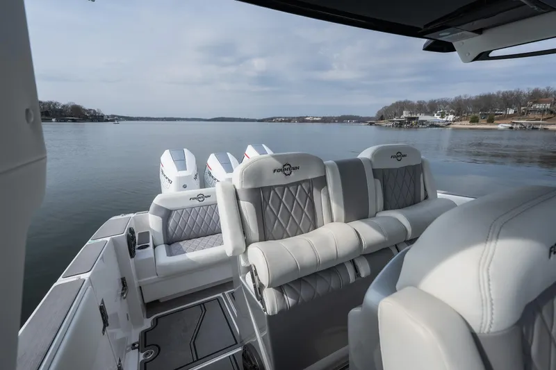  Yacht Photos Pics 2026 Fountain 38 SCX boat interior with luxurious seating on a calm lake.