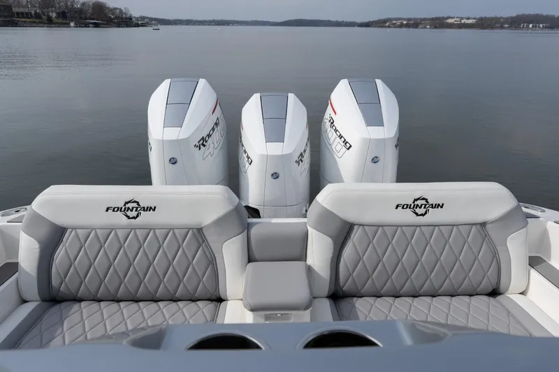  Yacht Photos Pics 2026 Fountain 38 SCX boat with triple outboard engines on a calm lake.