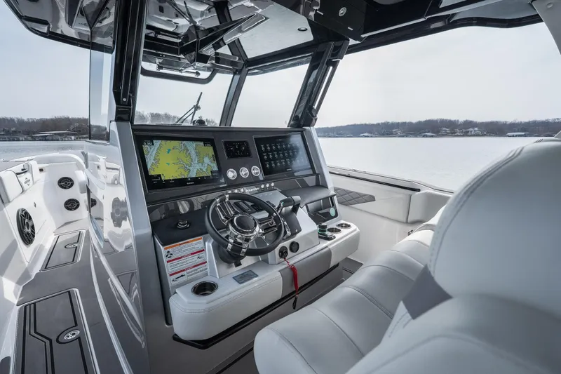  Yacht Photos Pics 2026 Fountain 38 SCX boat cockpit with advanced navigation system and luxurious seating.