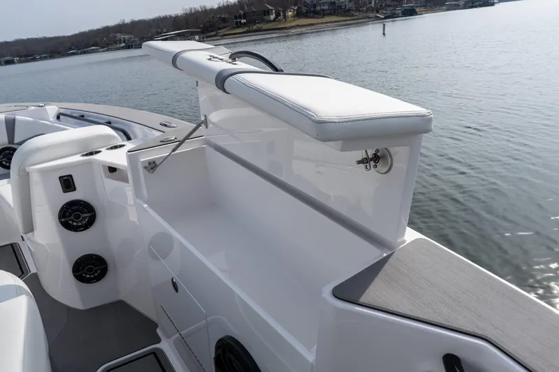  Yacht Photos Pics 2026 Fountain 38 SCX boat interior with seating and storage, on a calm lake.