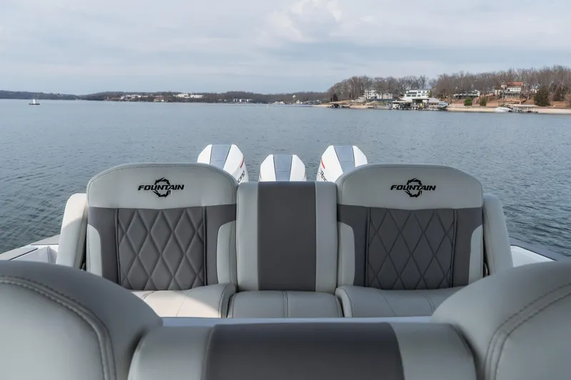  Yacht Photos Pics 2026 Fountain 38 SCX boat interior with luxurious seating on a serene lake.