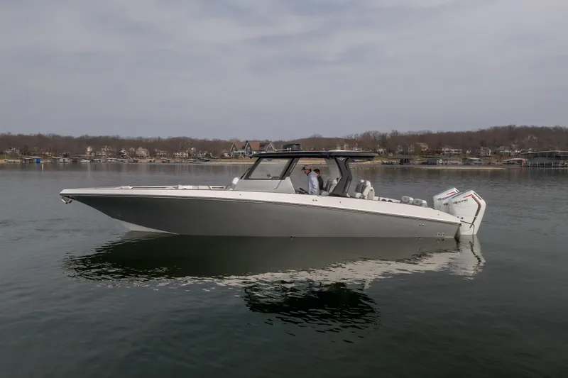  Yacht Photos Pics 2026 Fountain 38 SCX boat on calm lake with scenic background.