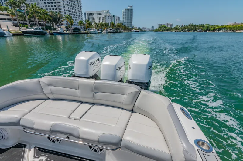  Yacht Photos Pics 2019 Nor-Tech 390 Sport boat cruising on a scenic waterway with city skyline views.