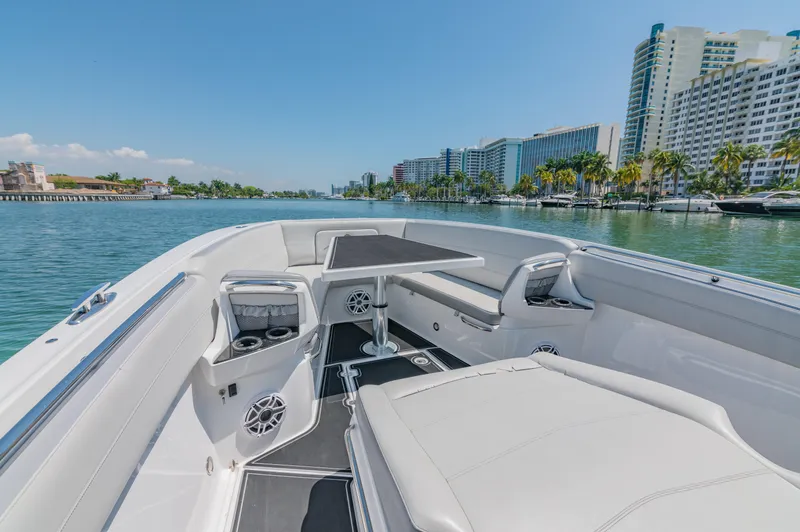  Yacht Photos Pics 2019 Nor-Tech 390 Sport boat interior with seating, table, and waterfront cityscape.