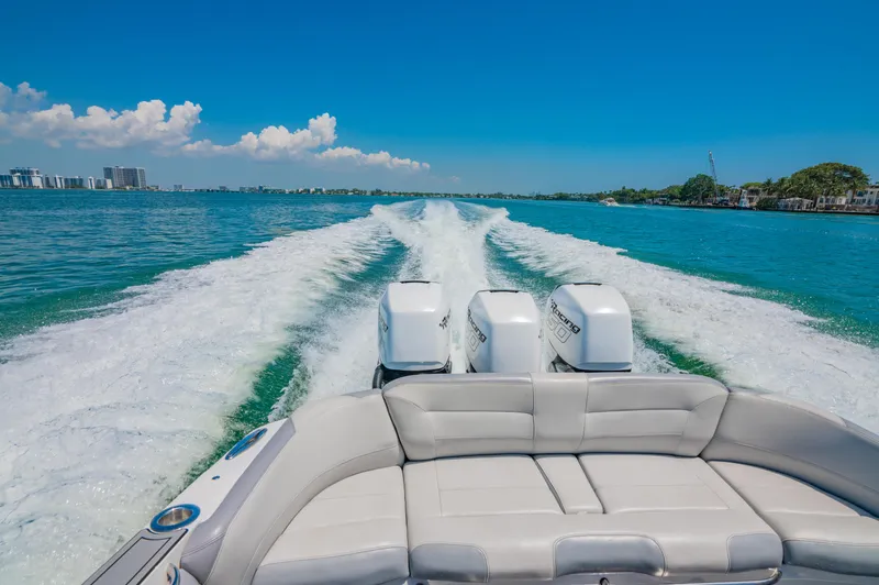  Yacht Photos Pics 2019 Nor-Tech 390 Sport boat cruising on clear blue water, leaving a wake behind.