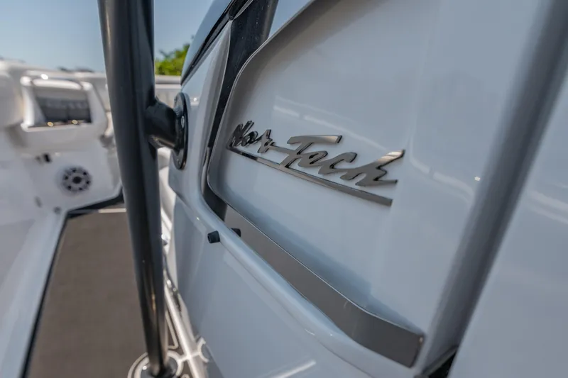  Yacht Photos Pics 2019 Nor-Tech 390 Sport boat, close-up of logo on sleek white exterior.
