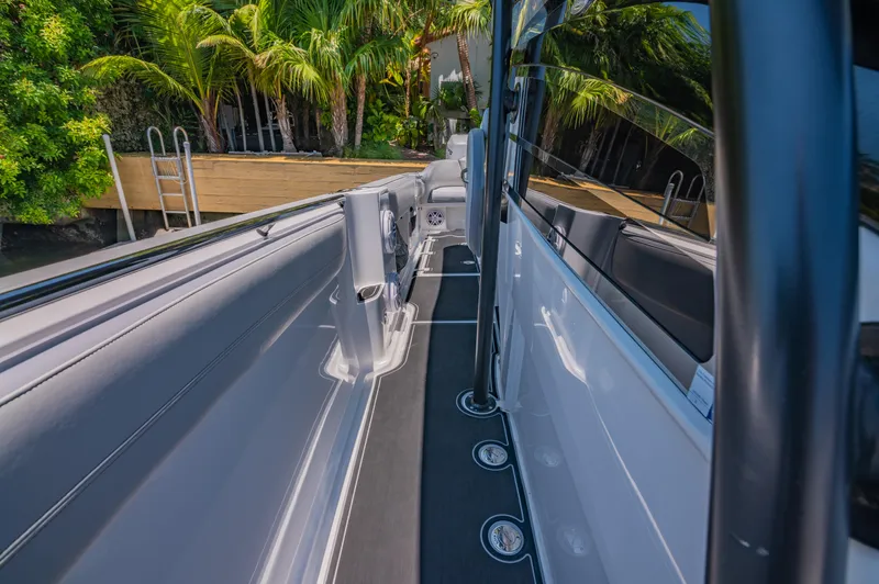  Yacht Photos Pics 2019 Nor-Tech 390 Sport boat deck with sleek design and lush greenery backdrop.