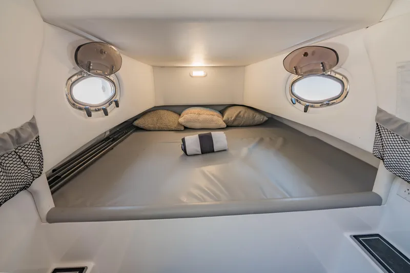  Yacht Photos Pics 2019 Nor-Tech 390 Sport cabin interior with cozy bed and portholes.
