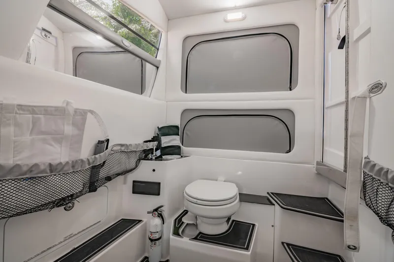  Yacht Photos Pics 2019 Nor-Tech 390 Sport boat interior bathroom with toilet and storage compartments.