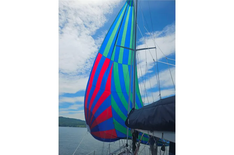  Yacht Photos Pics Colorful spinnaker sail on 1994 Sabre 362 yacht against blue sky.