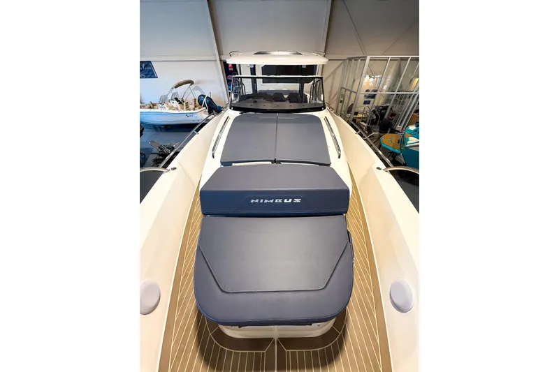  Yacht Photos Pics 2022 Nimbus T11 boat with cushioned deck, displayed indoors.