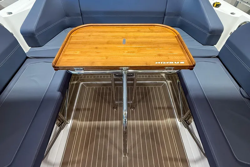  Yacht Photos Pics Luxurious seating area with wooden table on 2022 Nimbus T11 boat.