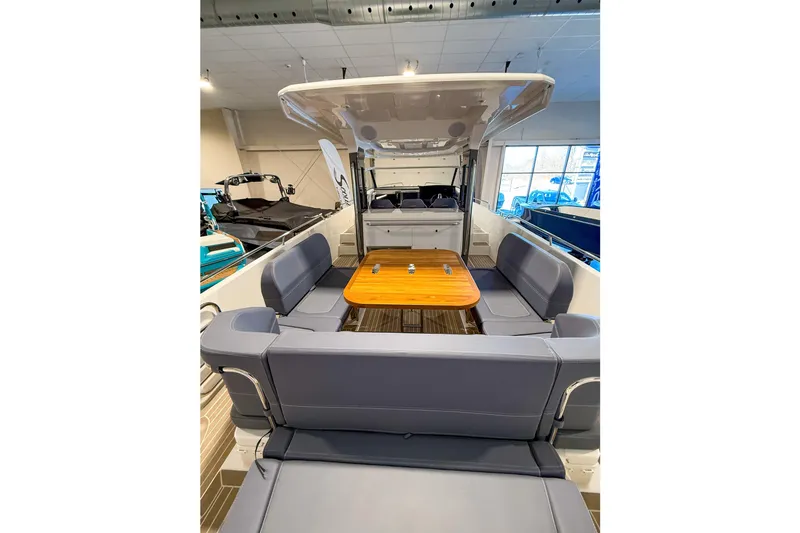  Yacht Photos Pics Luxurious 2022 Nimbus T11 boat interior with spacious seating and wooden table.