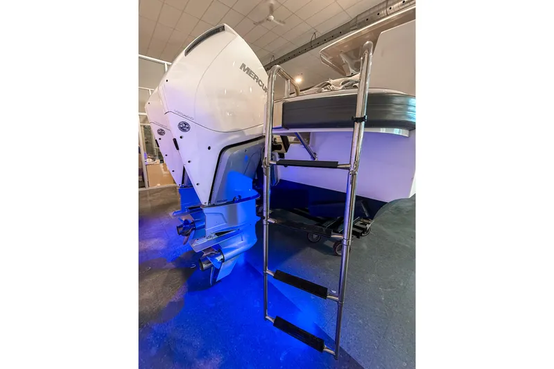  Yacht Photos Pics Nimbus T11 2022 boat with Mercury outboard engine and boarding ladder, illuminated by blue light.